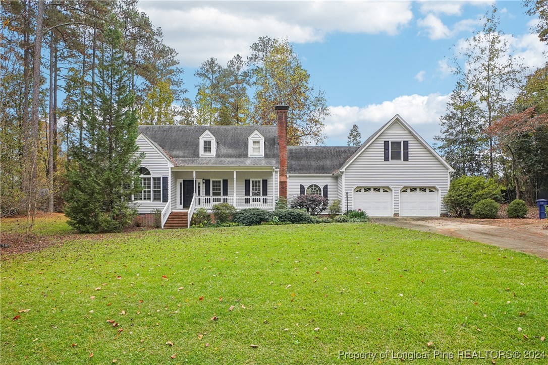 a front view of a house with yard and garage