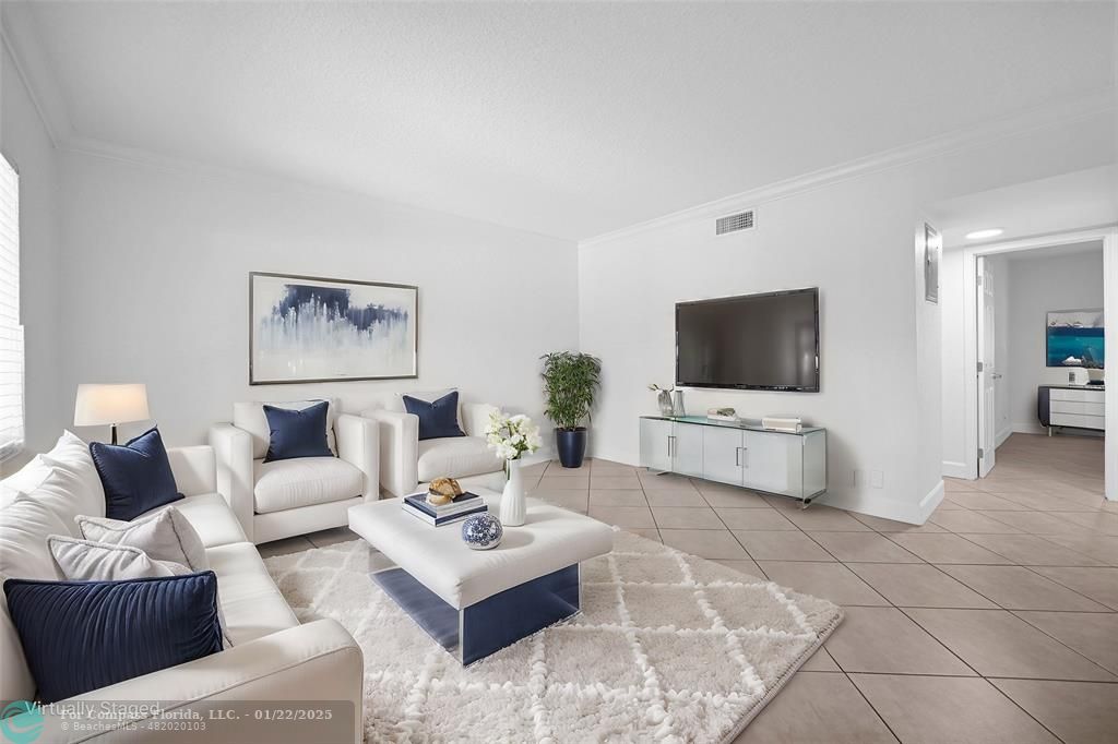 a living room with furniture and a flat screen tv