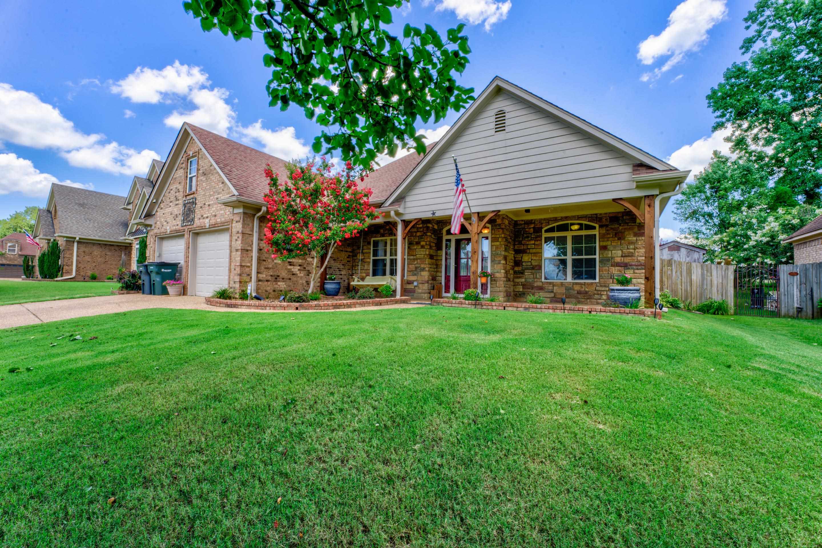 a front view of house with yard and outdoor seating