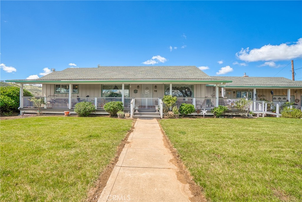 a view of house with a yard