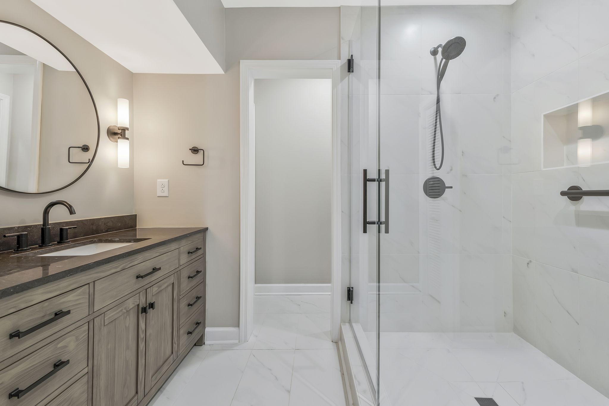 a bathroom with a double vanity sink mirror double and shower