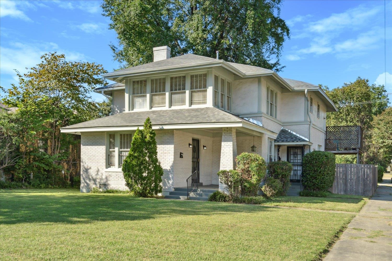 a front view of a house with a garden