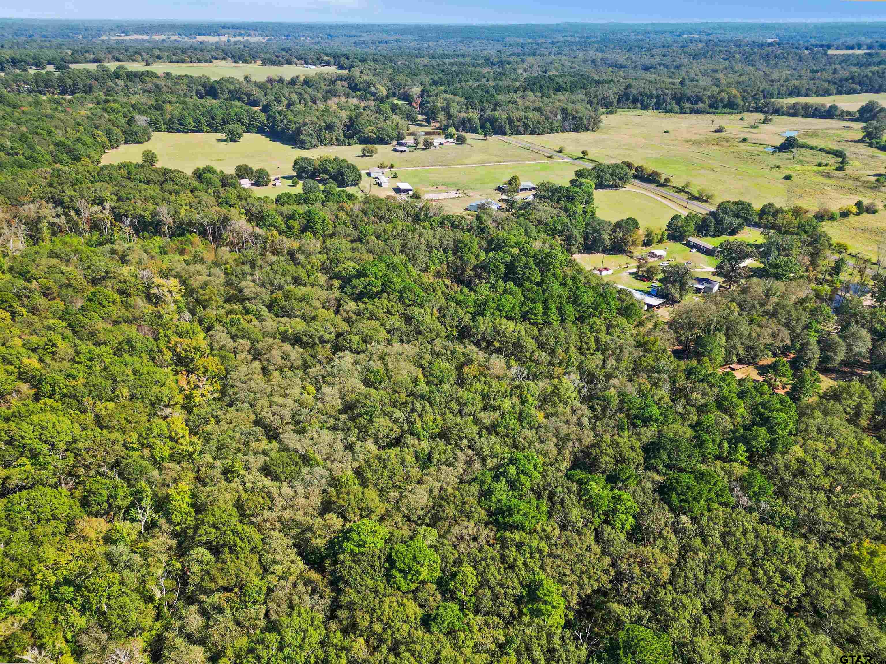 an aerial view of a houses with a yard