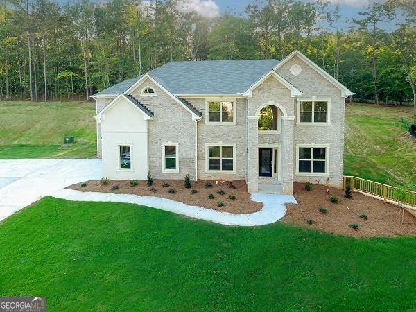 a aerial view of a house with backyard sitting area and garden