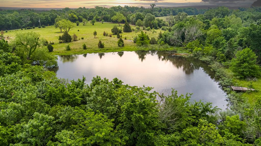 an aerial view of a houses with a lake view