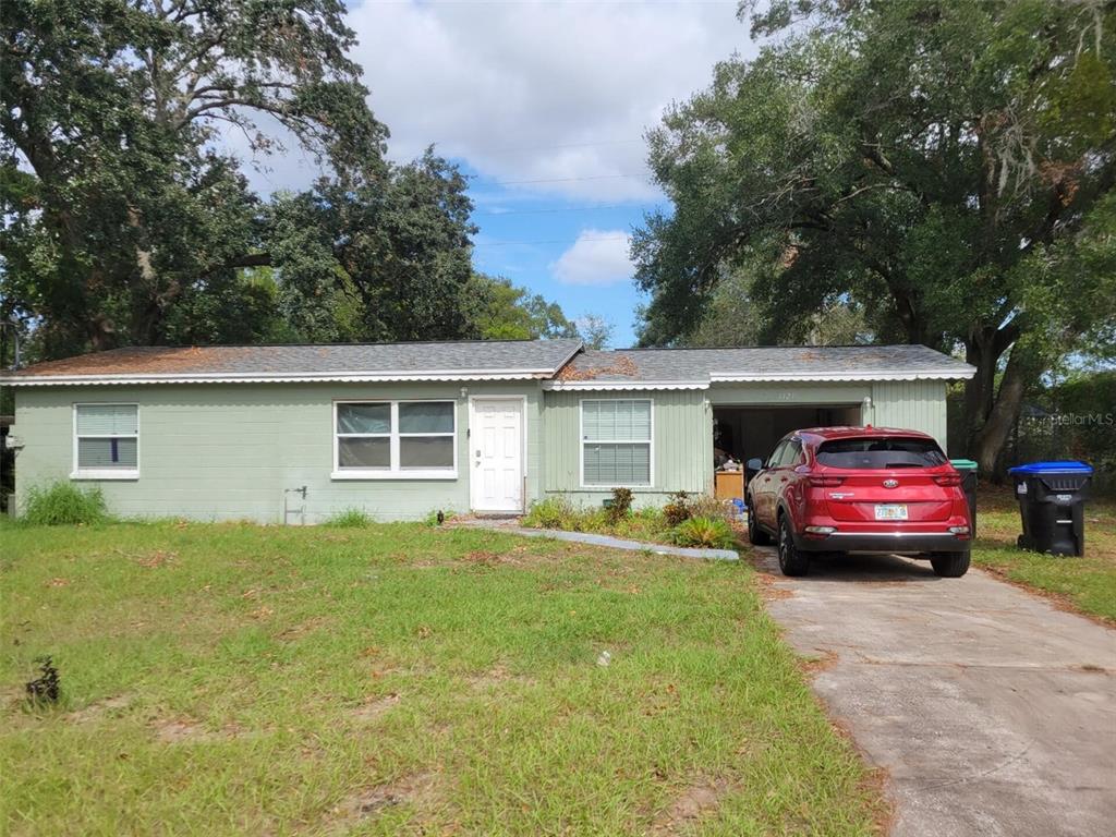 a view of house that has a yard