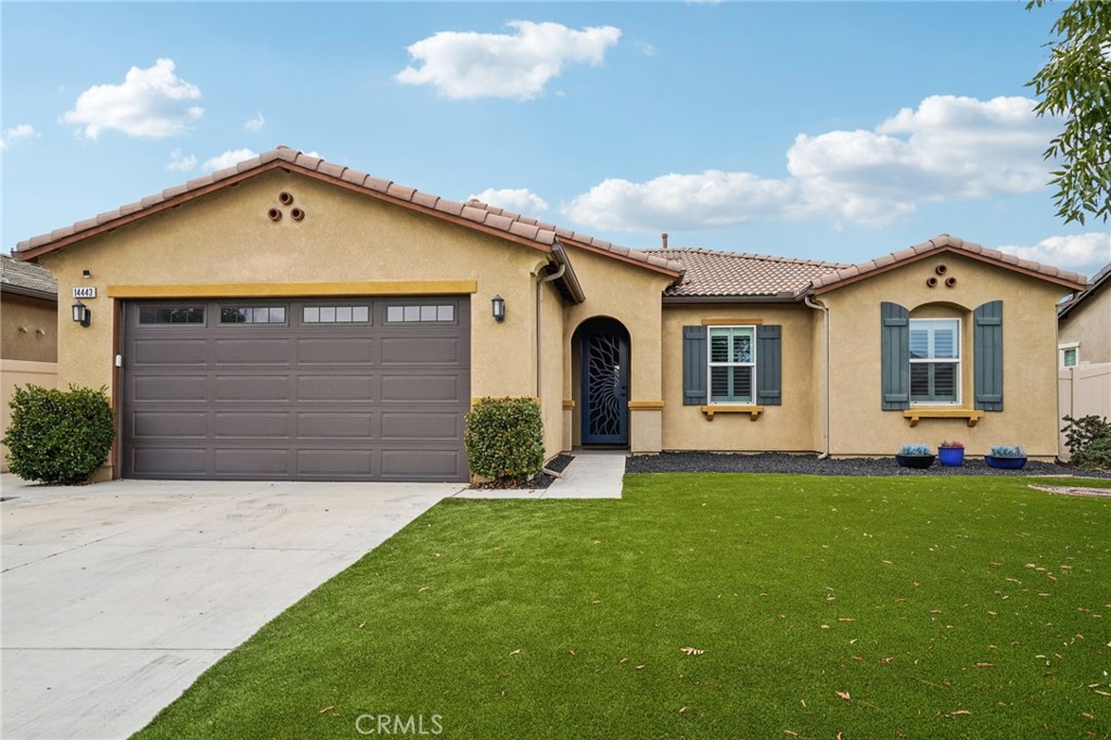 a front view of a house with a yard and garage