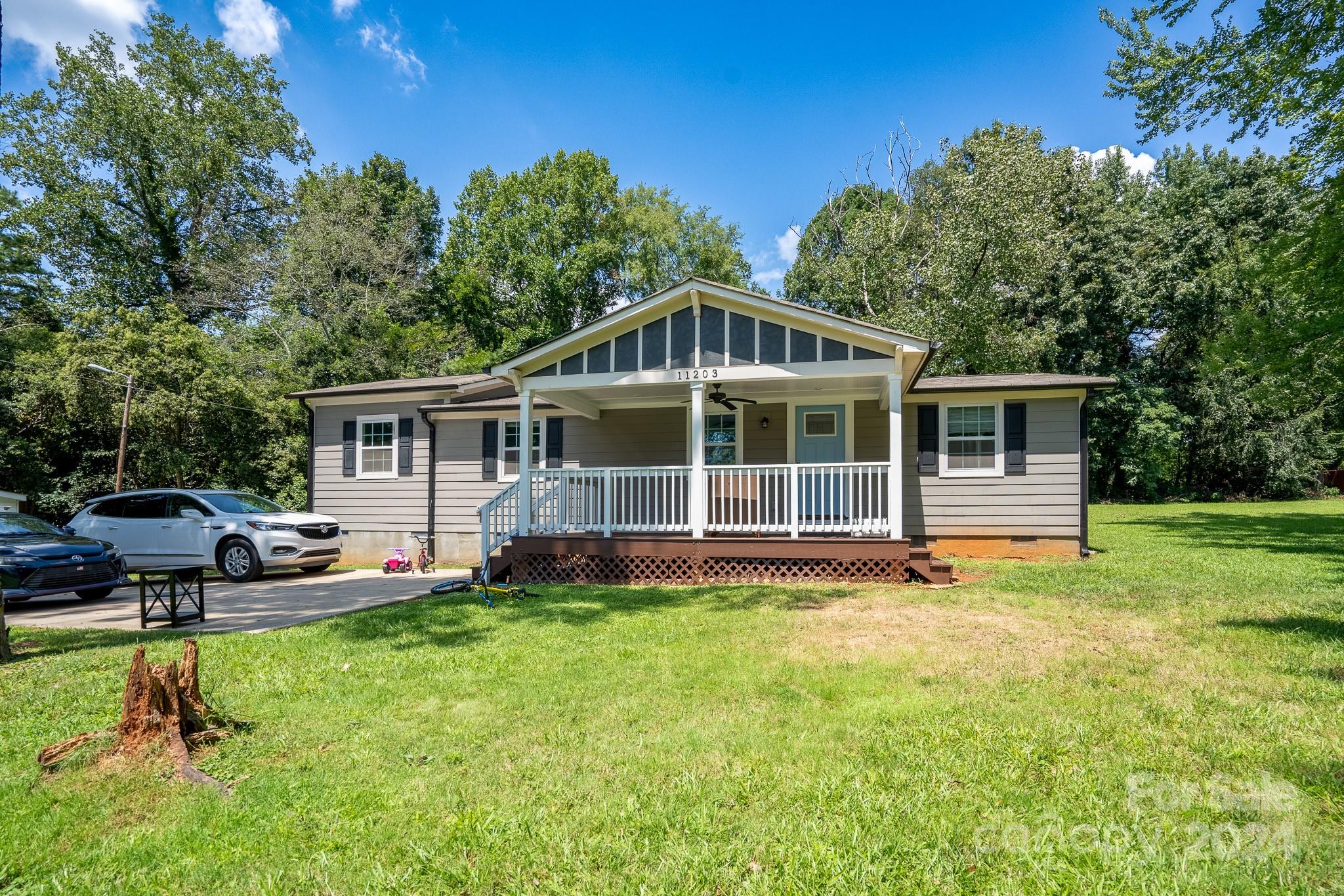 a view of a house with a backyard porch and sitting area