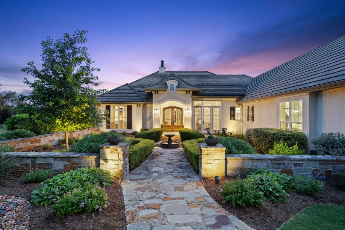 a front view of a house with garden