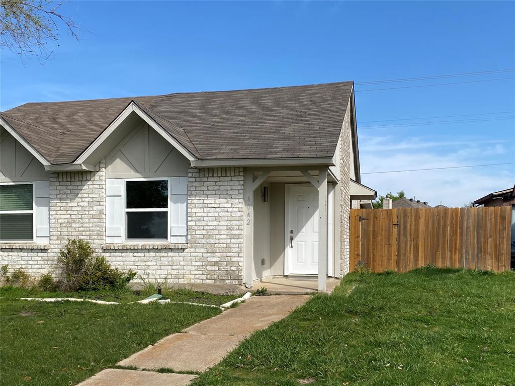 a brick house with a yard