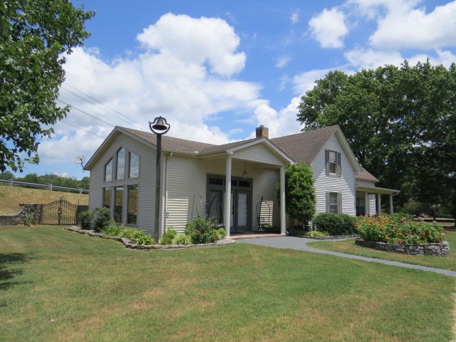 a front view of house with yard and green space