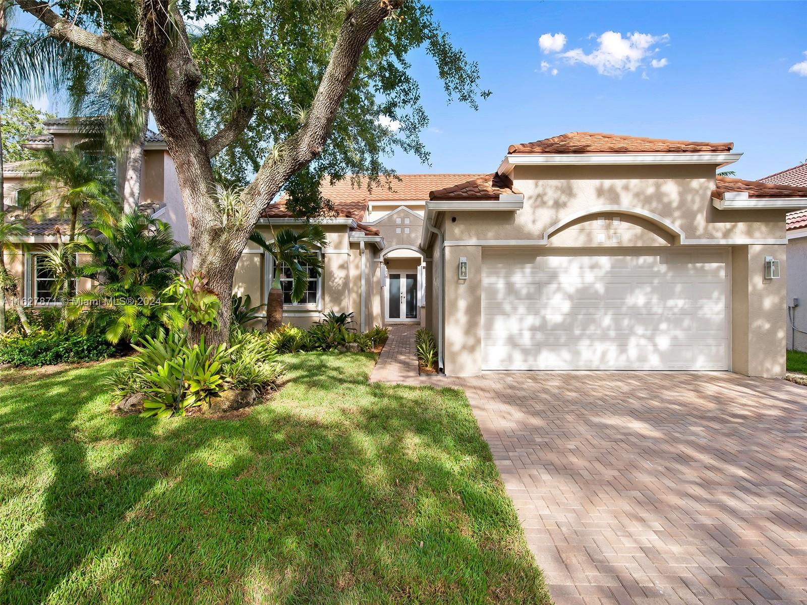 a front view of a house with a garden