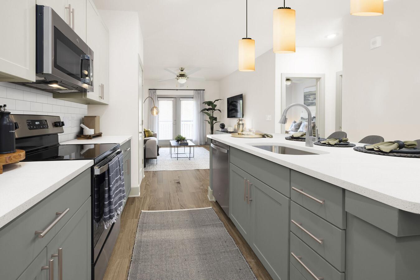 a kitchen with stainless steel appliances a sink stove and cabinets