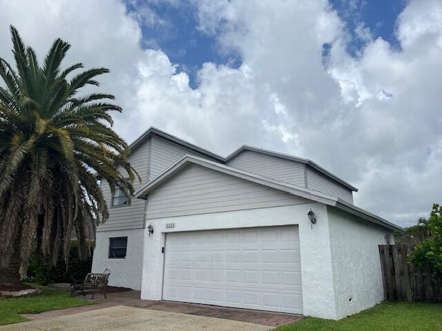 a house with palm tree in front of it