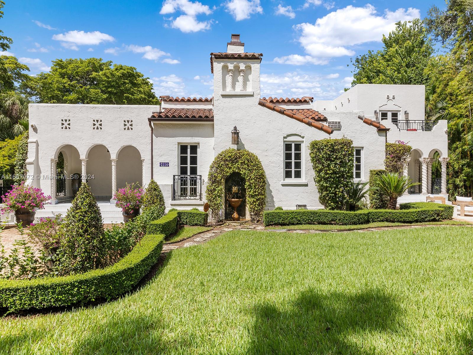 a front view of a house with garden