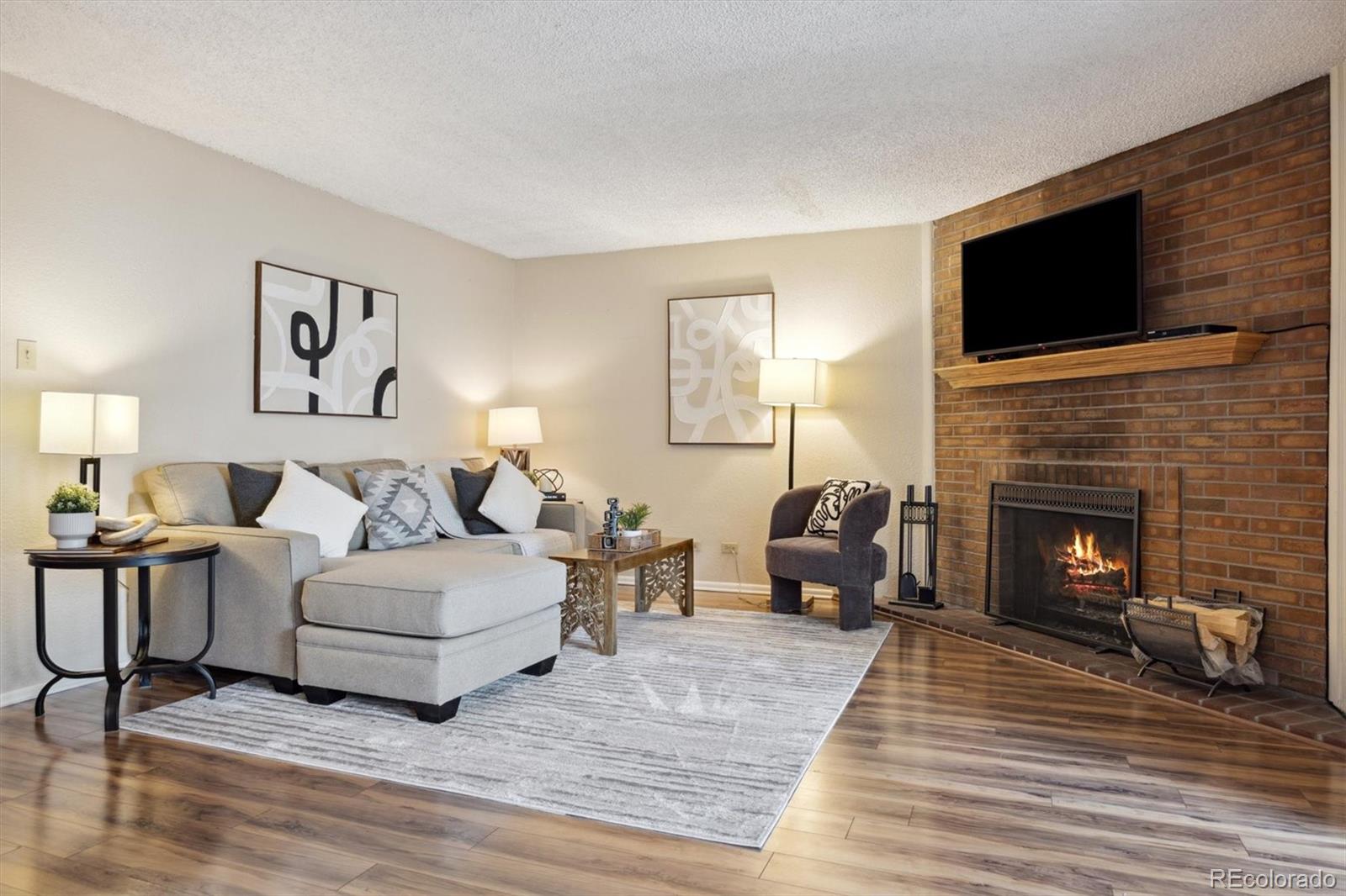 a living room with furniture fireplace and flat screen tv