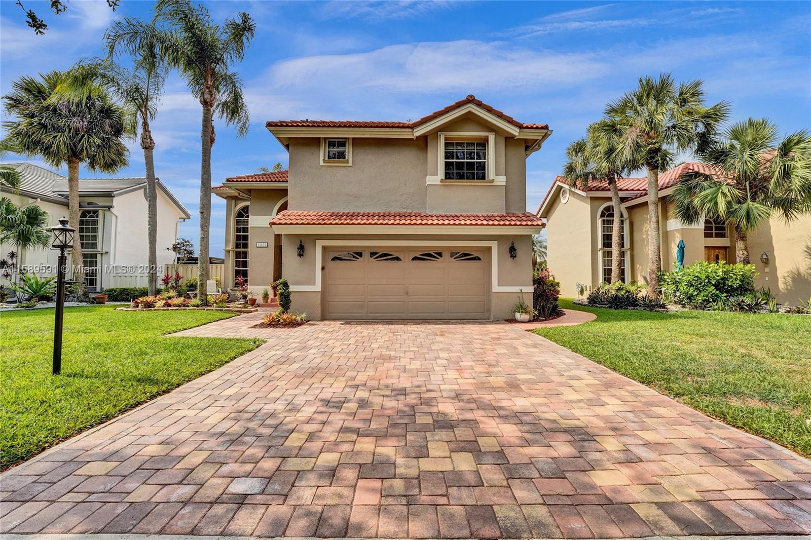 a front view of a house with a yard and garage