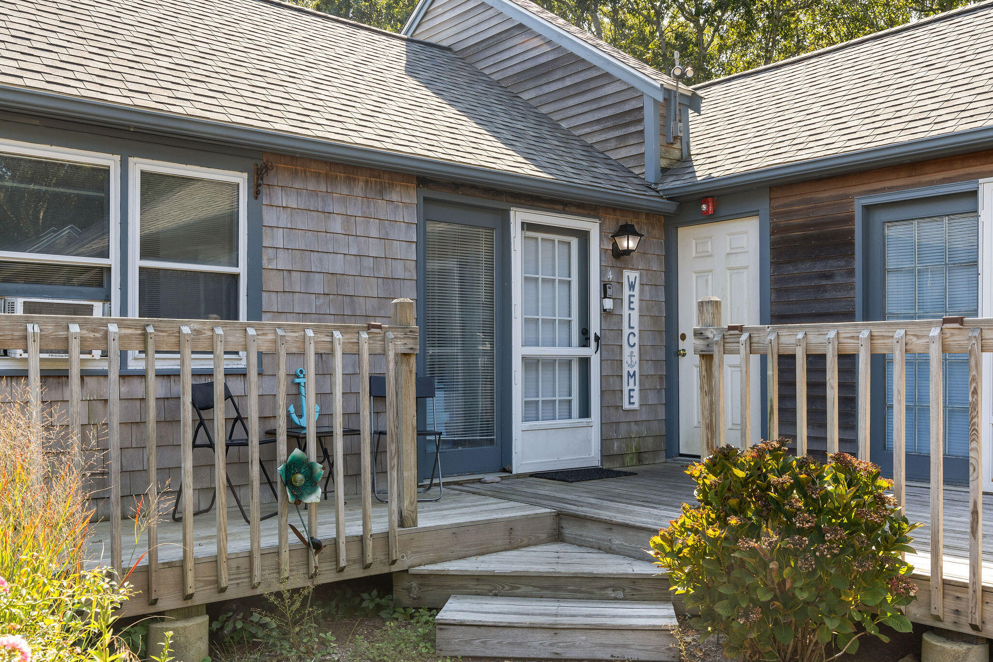 a front view of a house with a garden