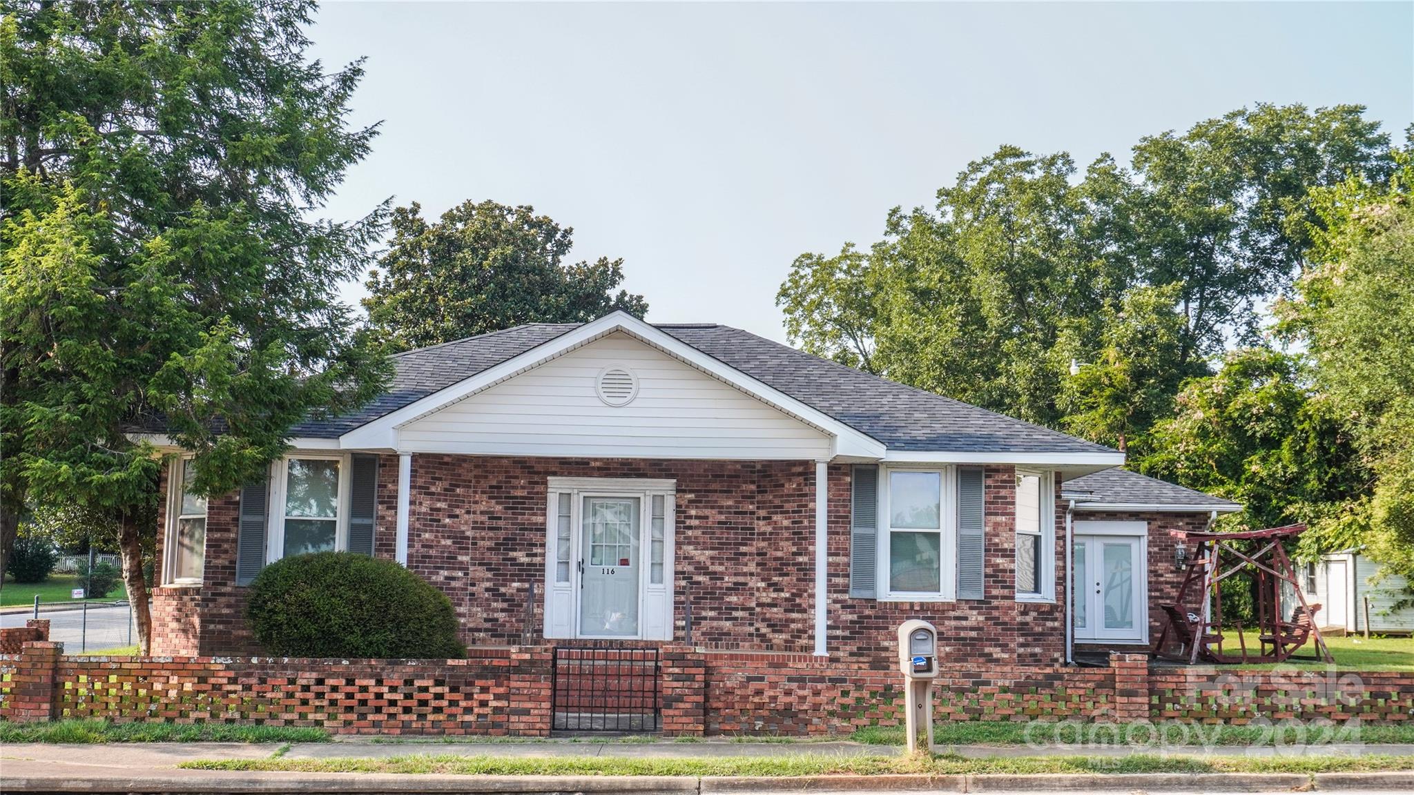 a front view of a house with a garden