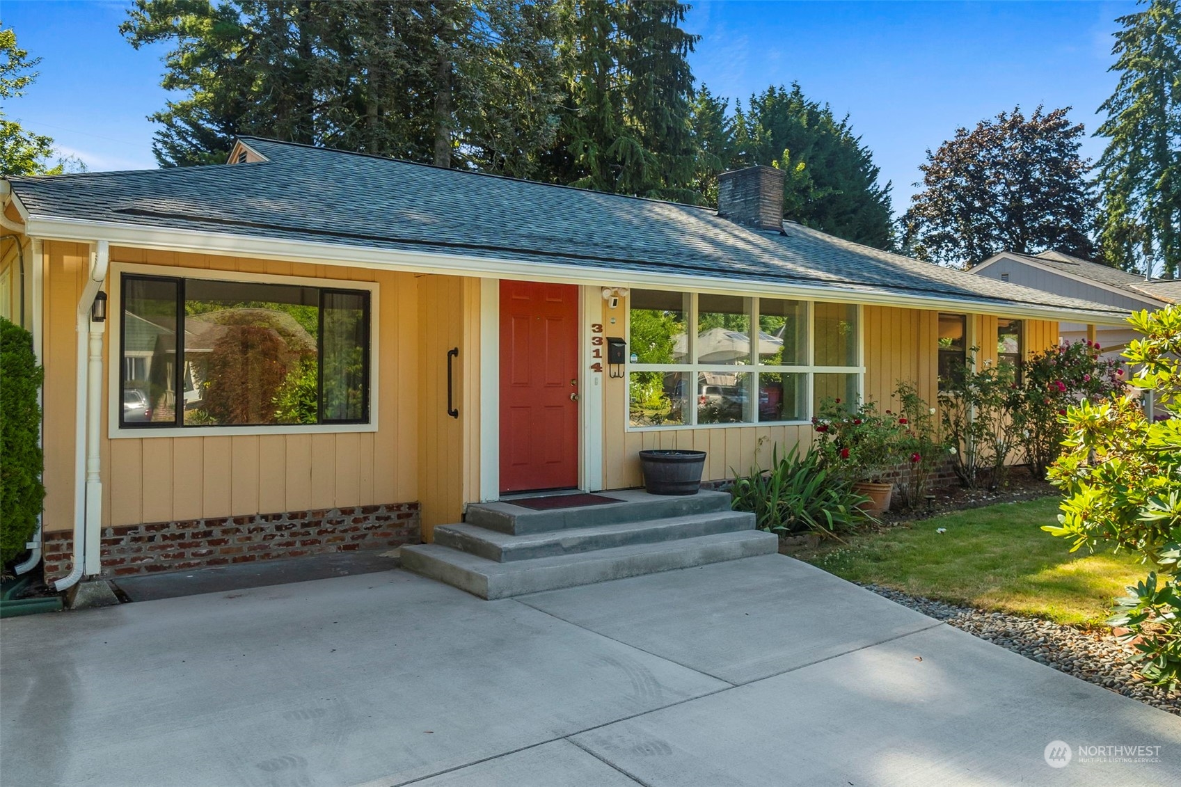 a view of house with backyard and outdoor seating