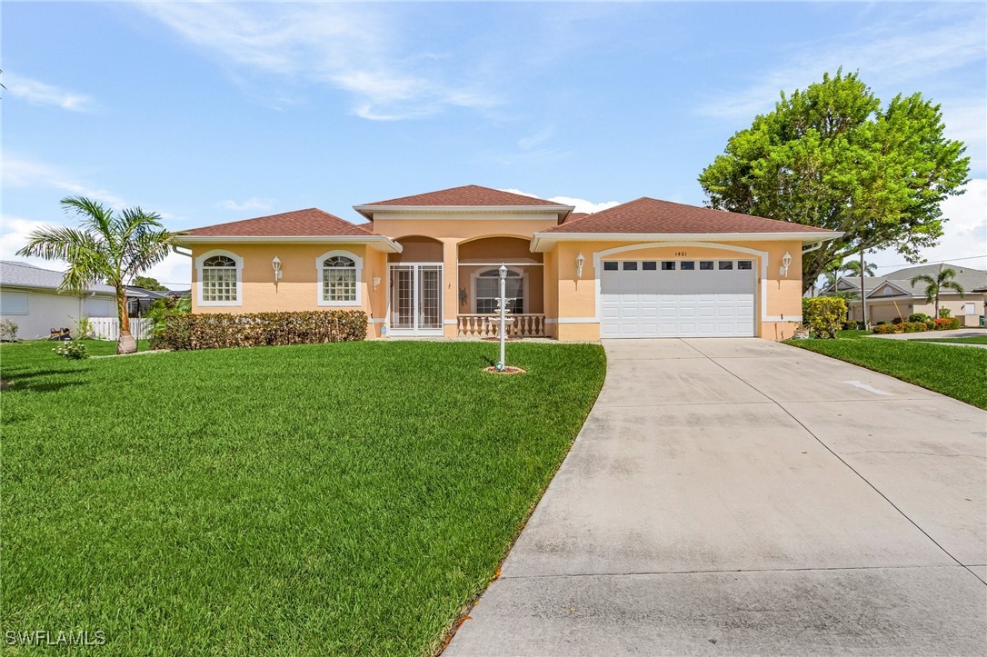 a front view of a house with a yard and garage