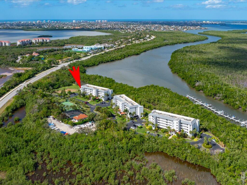 an aerial view of river residential houses with outdoor space and swimming pool