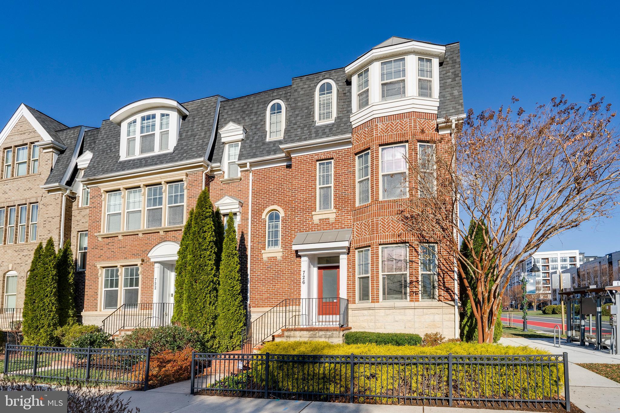 a front view of a residential apartment building with a yard