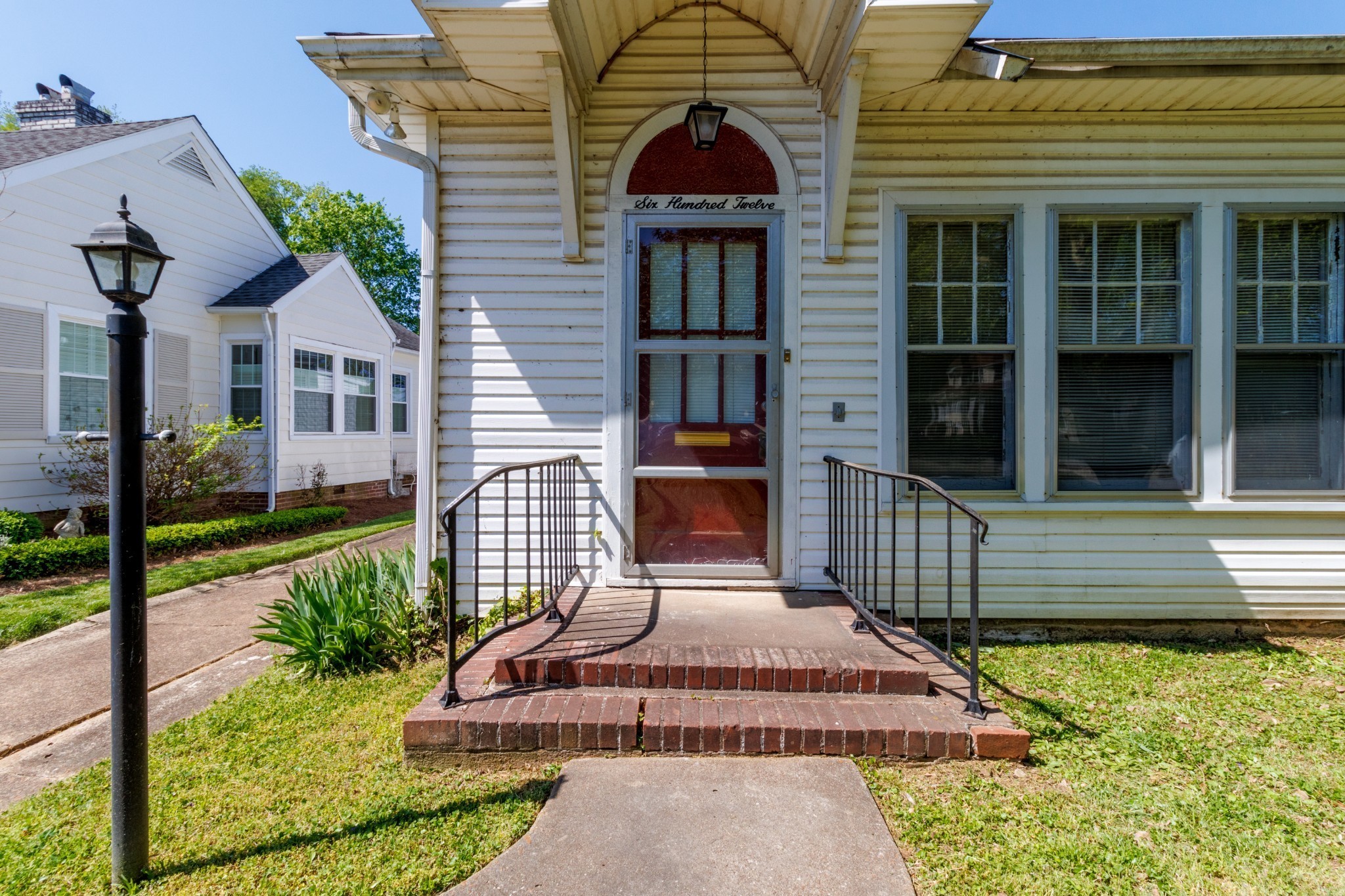 a front view of a house with a garden