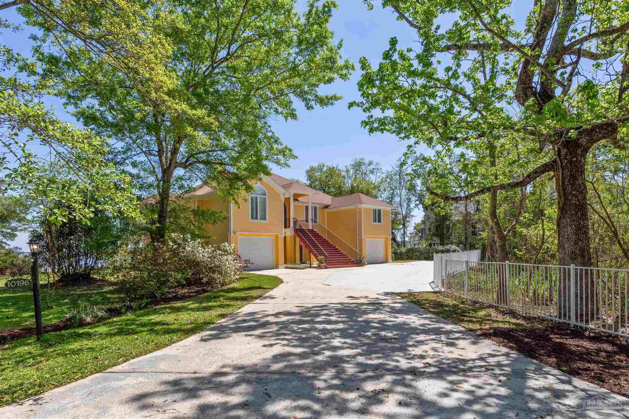 a view of a house with a tree in the background