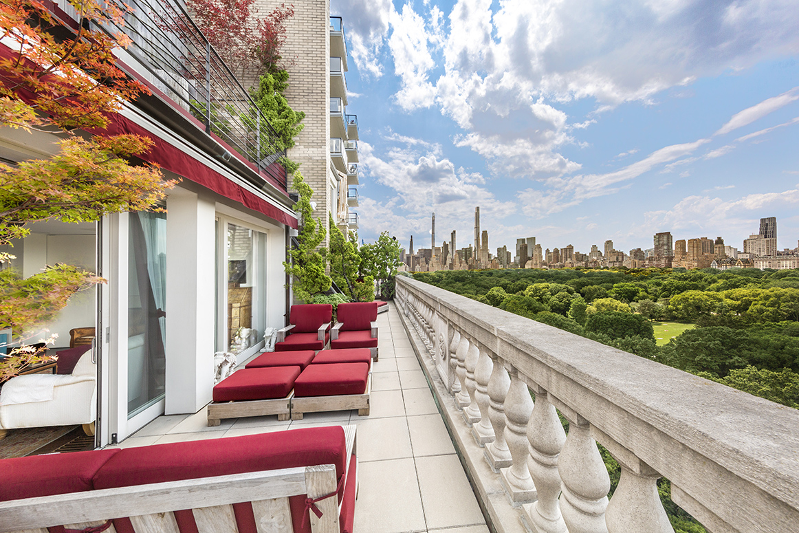 a balcony with an outdoor seating