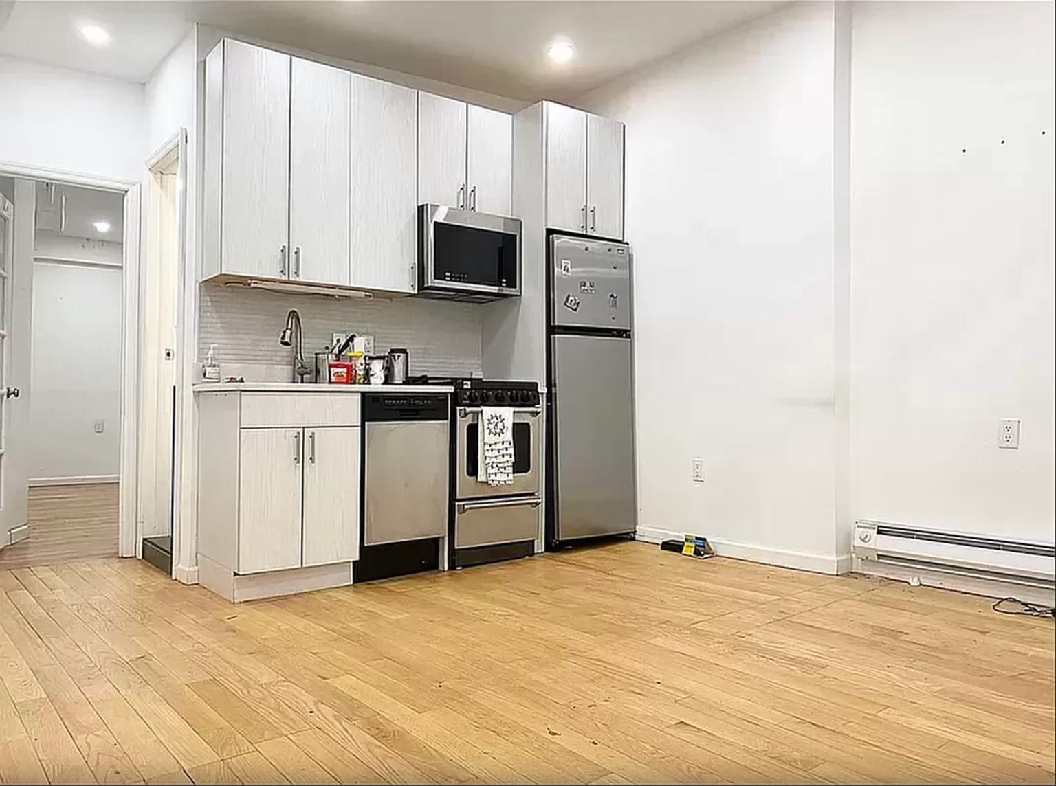 a kitchen with stainless steel appliances a sink and a refrigerator