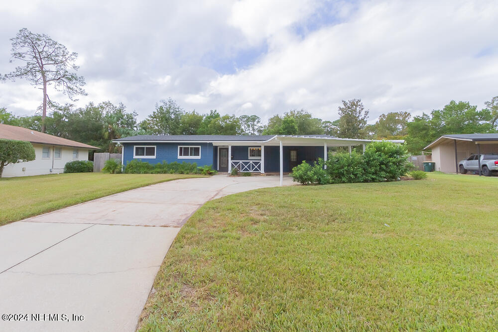 a view of house with yard outdoor seating and barbeque oven