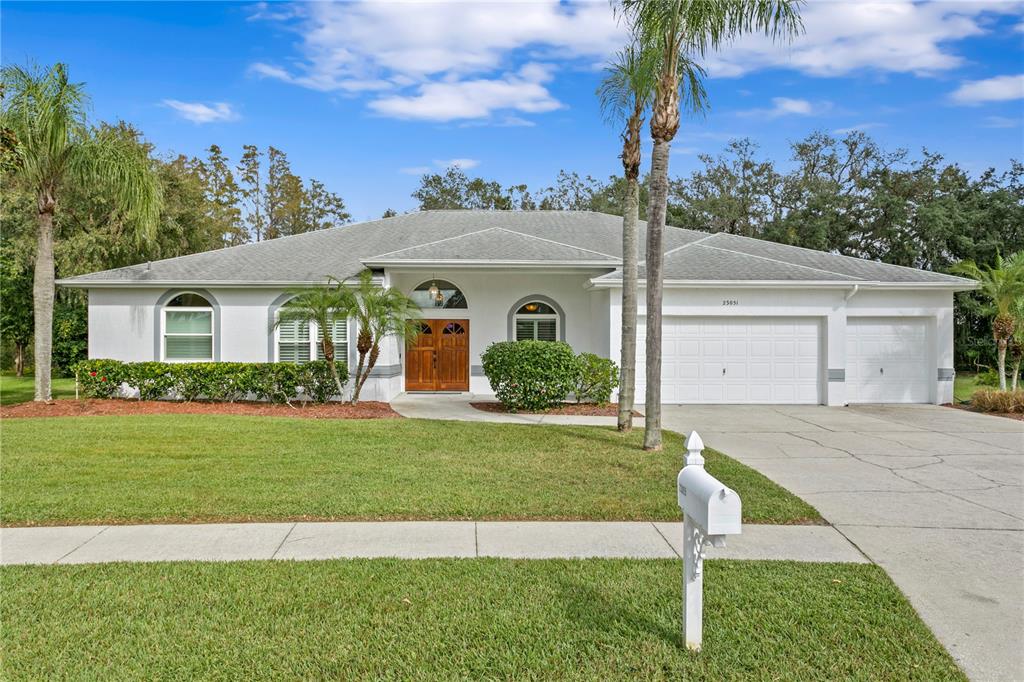 a front view of a house with a yard and garage