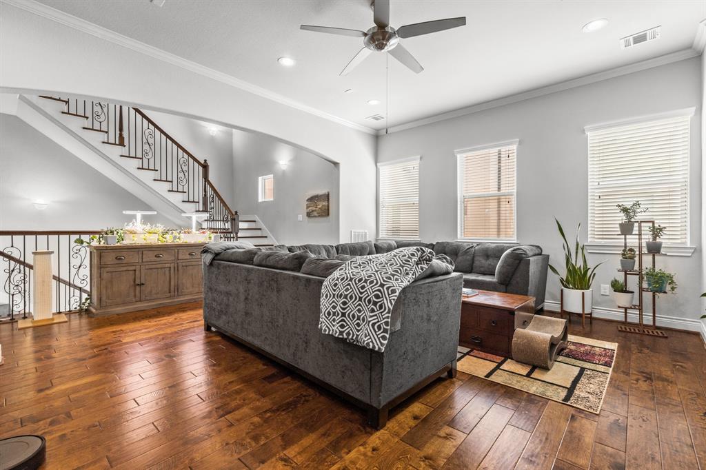 a living room with furniture and wooden floor