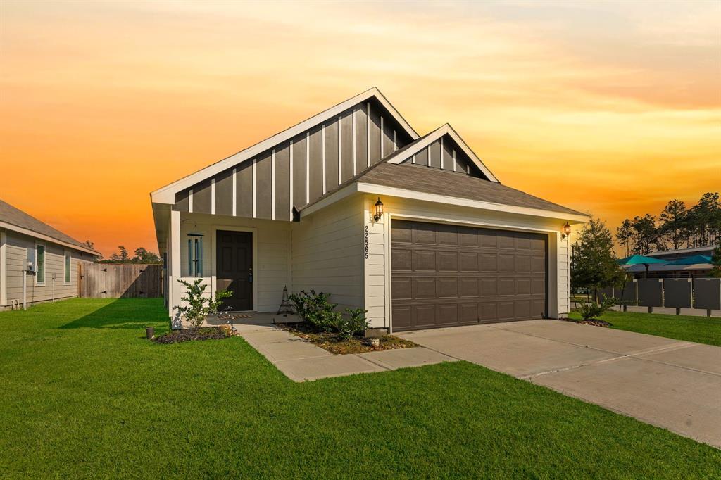 a front view of a house with a yard and garage