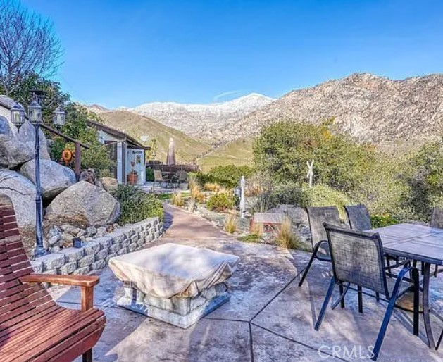 a view of a terrace with furniture and mountain view