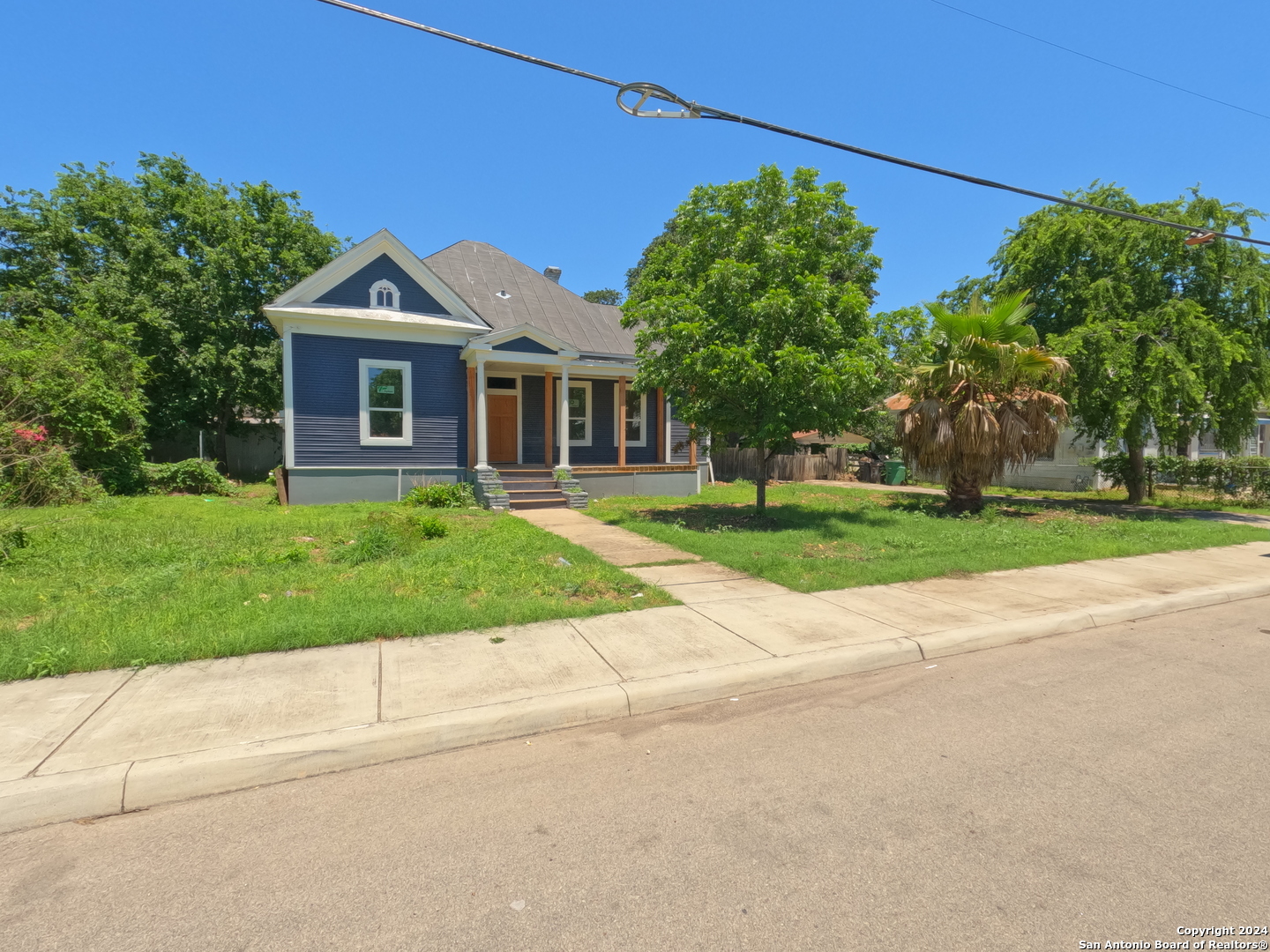 a front view of house with yard and green space