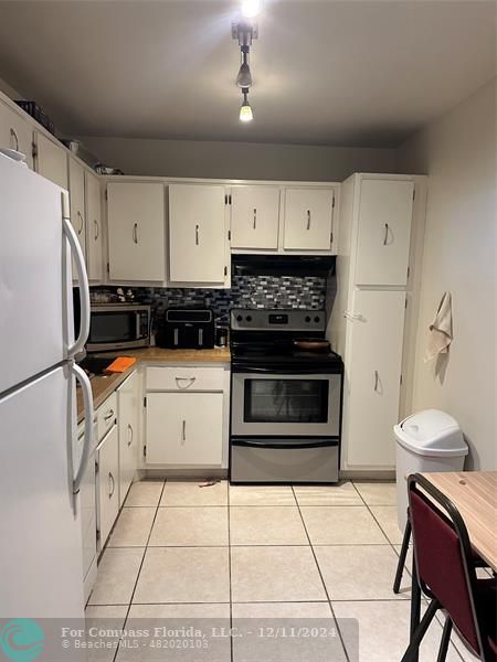 a kitchen with a stove a refrigerator and a stove