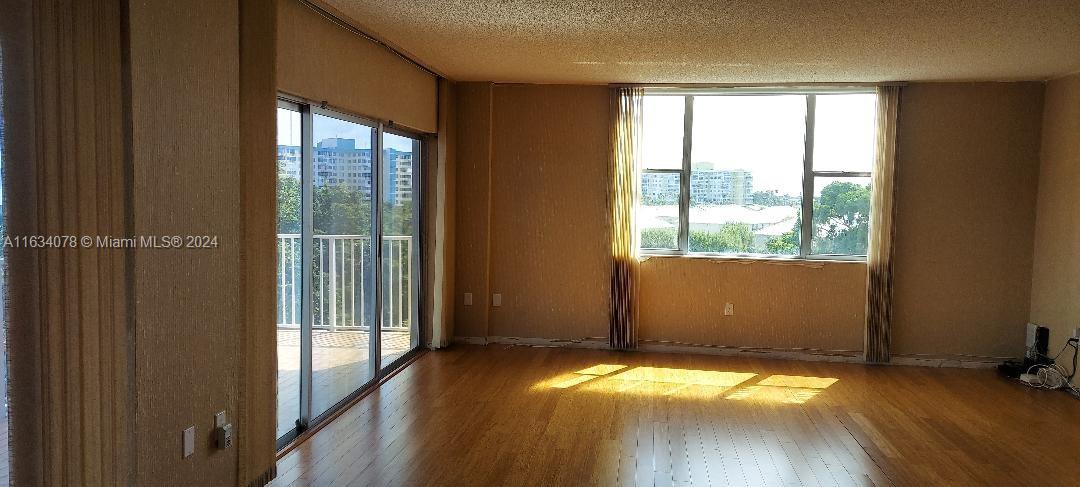 a view of a room with wooden floor and a window