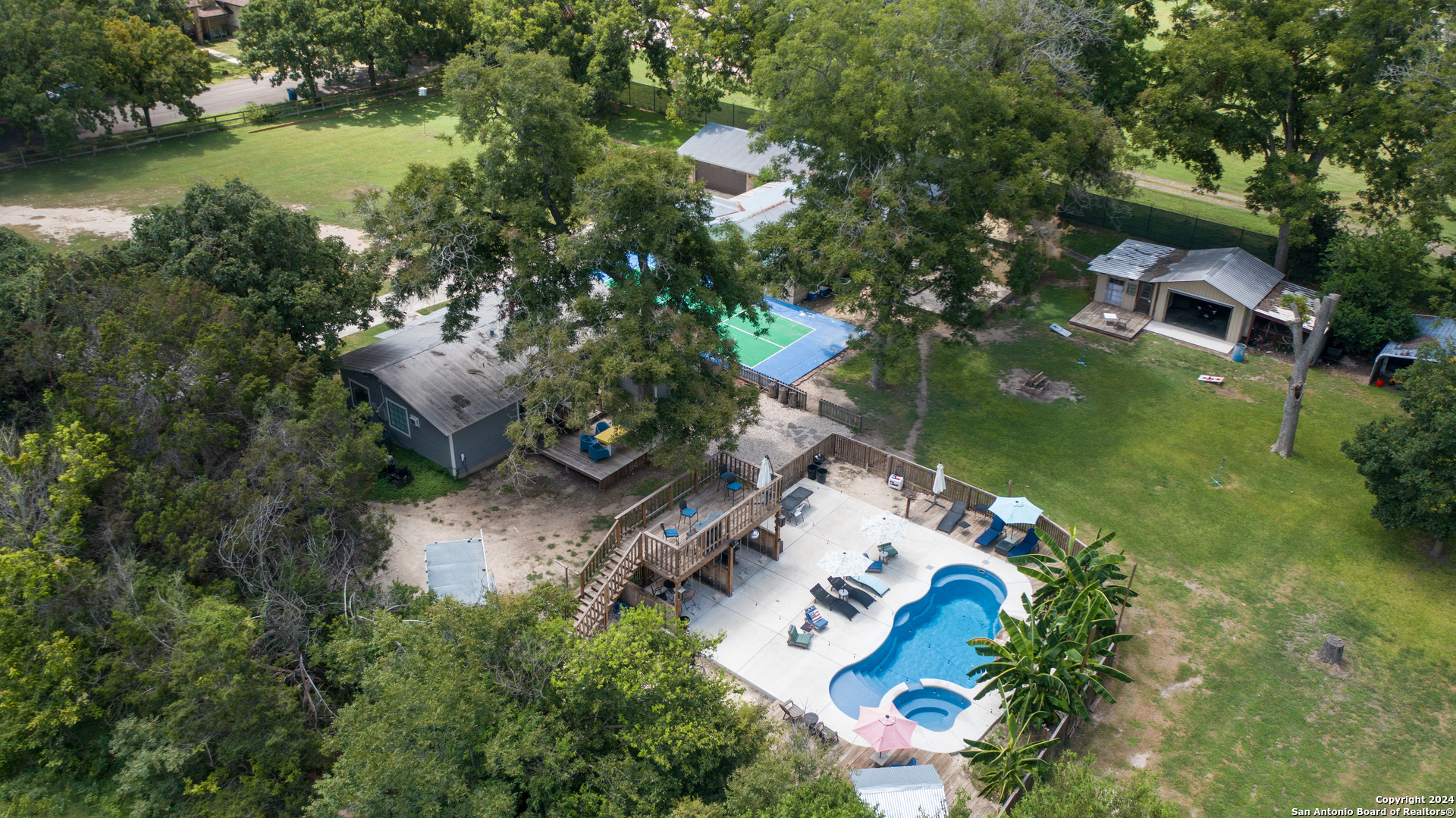 an aerial view of a house with a garden and lake view