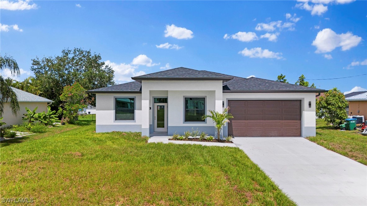 a front view of a house with a yard and garage