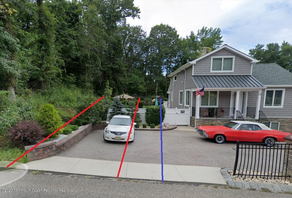 a front view of a house with a garden and parking