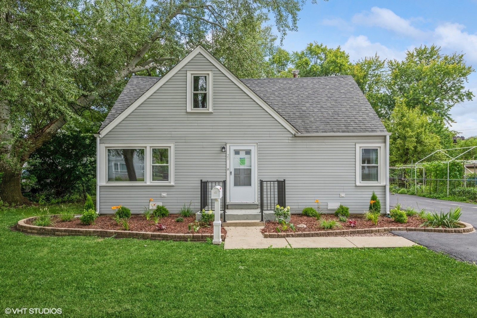 a front view of a house with patio and garden