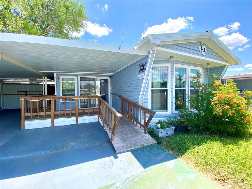 a view of a house with backyard porch and sitting area