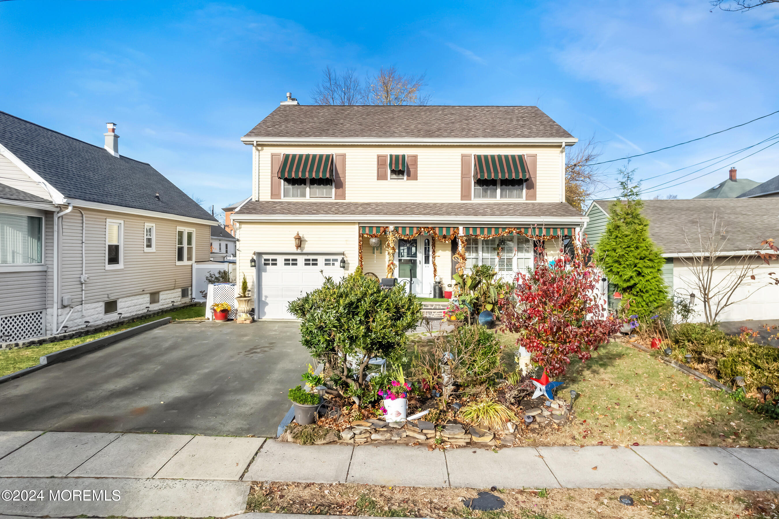 a front view of a house with a garden