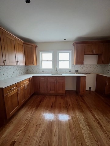 a kitchen with wooden floors and wooden cabinets