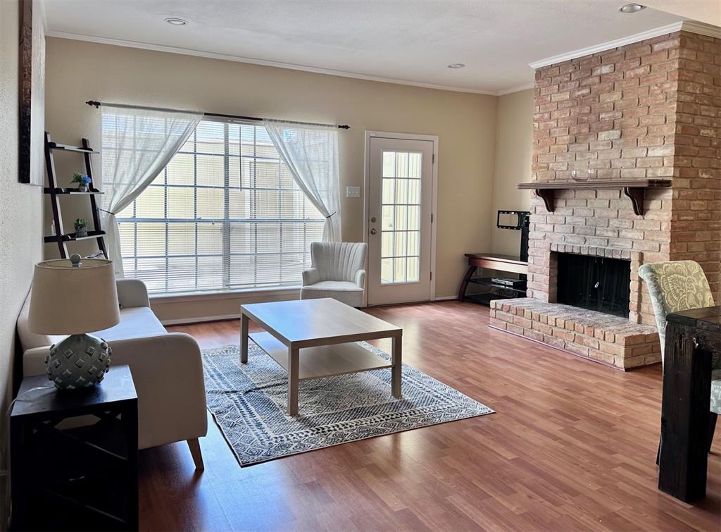 a living room with furniture a fireplace and a table