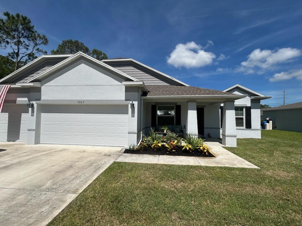 a front view of a house with a yard and garage