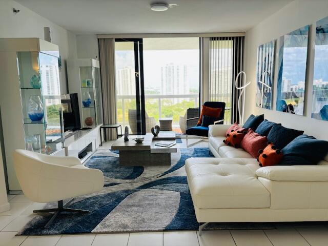 a living room with furniture and large windows