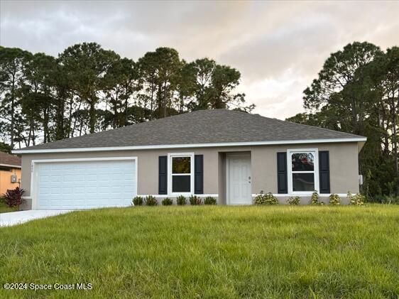 a front view of house with yard and green space